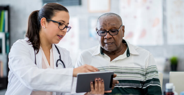 Doctor showing patient a tablet screen