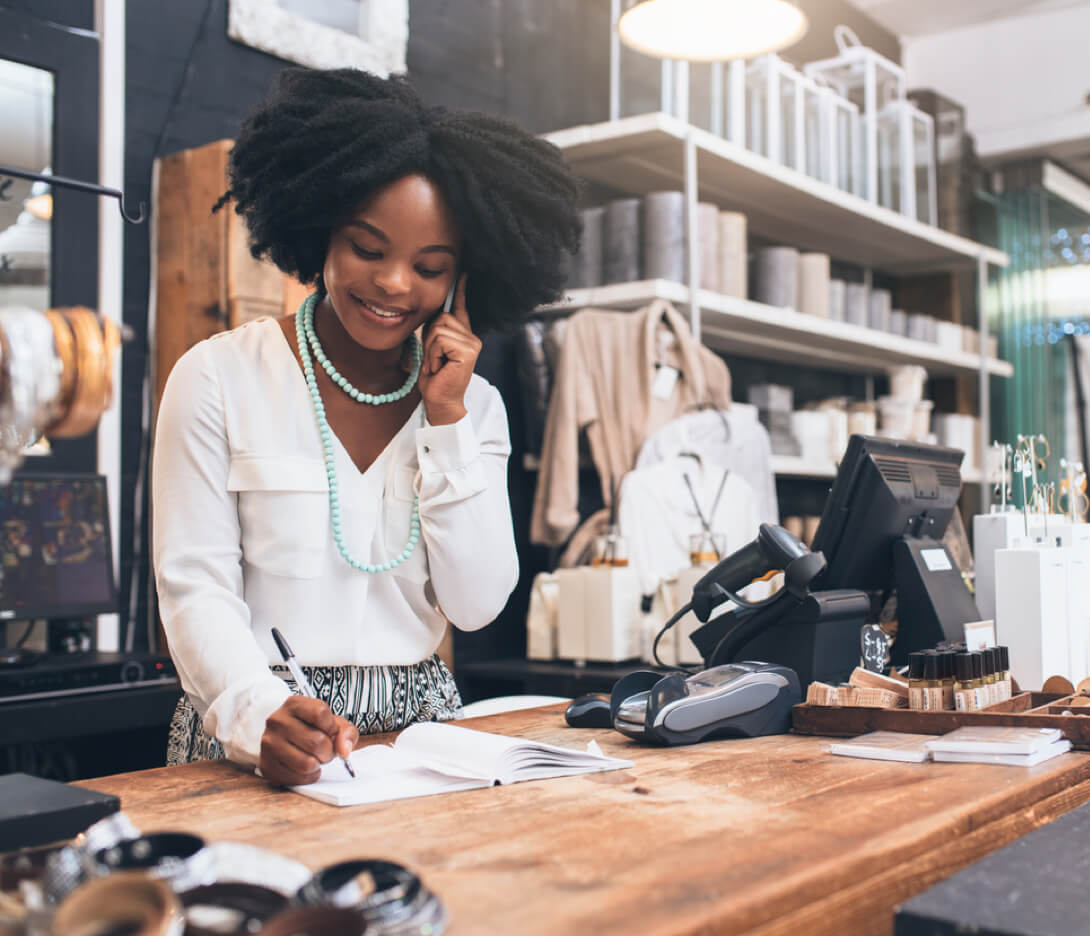 Retailer worker talking on phone and smiling