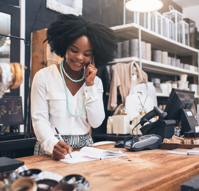 Retailer worker talking on phone and smiling