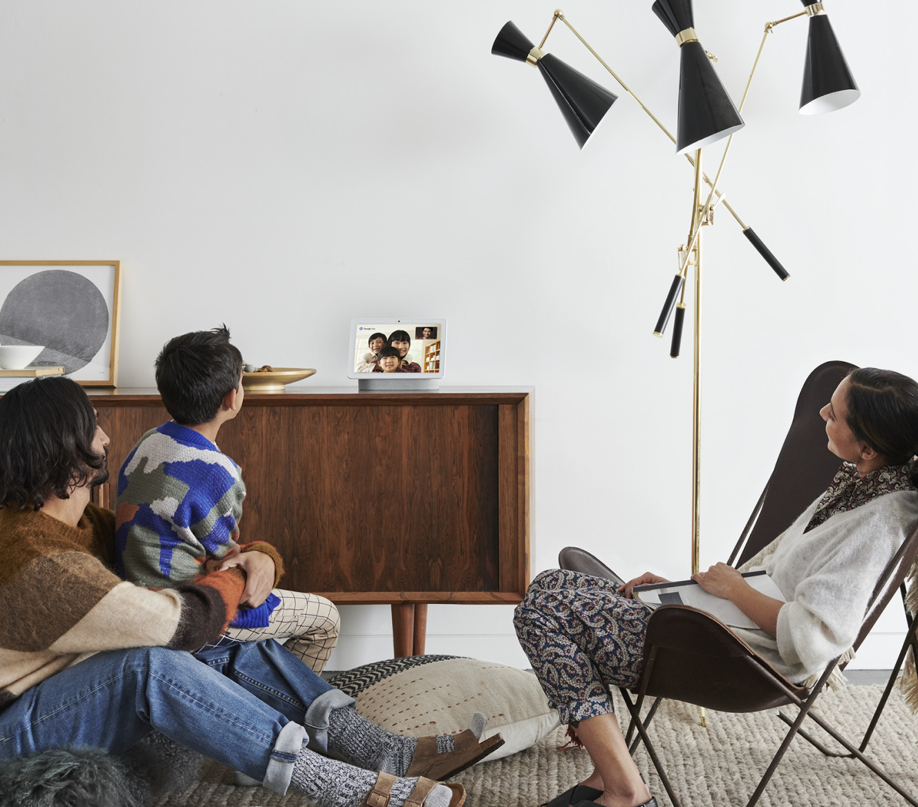 Family doing a Google Meet video call on their Google Nest Hub Max