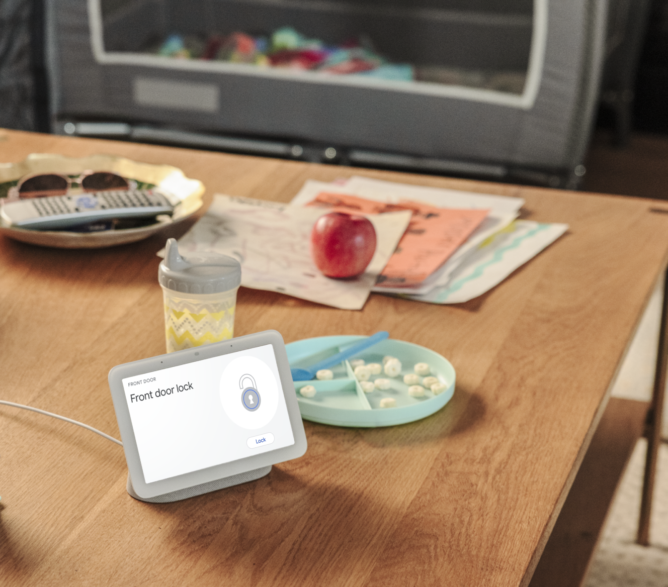 Google Nest Hub 2nd Gen on a kitchen table showing that a home's front door is locked